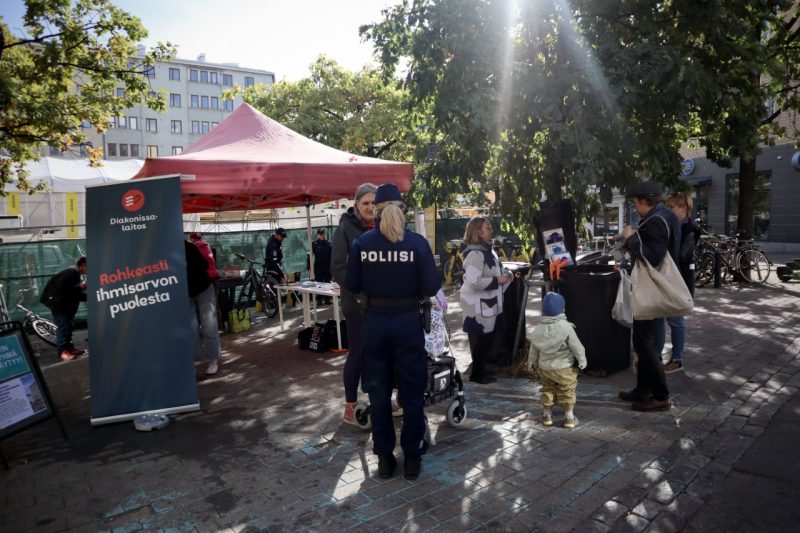 Kesätapahtuma, yhden henkilön selässä lukee Poliisi.